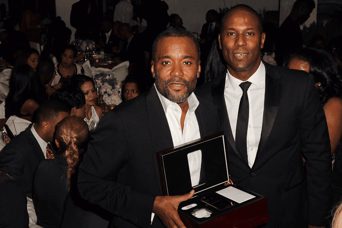 Laban Roomes awarding Director Lee Daniels with a 24k Gold iPhone for film Director achievements